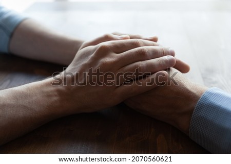 You are not alone daddy. Close up of young man hands covering wrinkled palms of mature old man grandfather help in difficult life situation. Compassionate grown son support father retiree in crisis Royalty-Free Stock Photo #2070560621