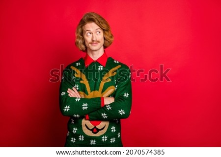 Photo of confident pretty young guy dressed print pullover smiling arms crossed looking empty space isolated red color background