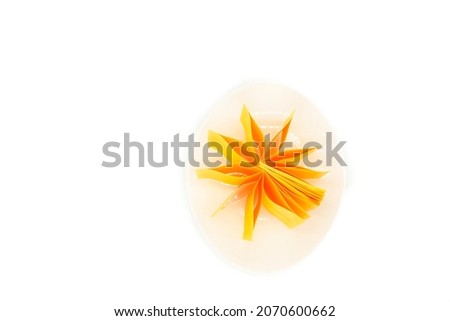 abstract conceptual photography of crashed egg with a plate and paper in the center arranged as a flower