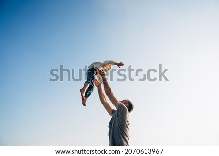 Father and son playing in the park at the sunset time. Family, trust, protecting, care, parenting, summer vacation concept Royalty-Free Stock Photo #2070613967