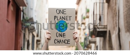 Demonstrator on the city protesting against climate change and pollution - Global warming and environment concept