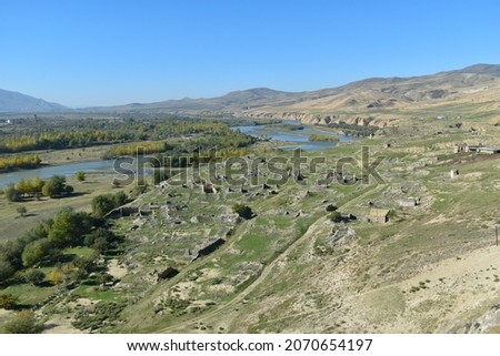 View at Mtkvari river or Kura river from the rock cave city Uplistsikhe in Georgia, Asia. River bank with autumn trees and hills in the background. Royalty-Free Stock Photo #2070654197