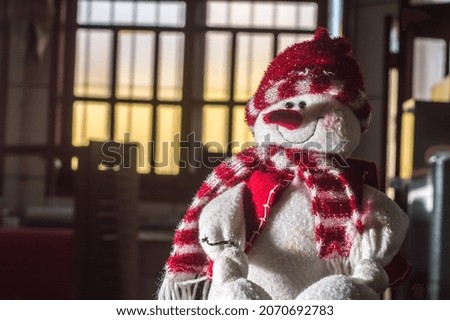Christmas concept with happy snowman, copy space and selective focus, dark background.