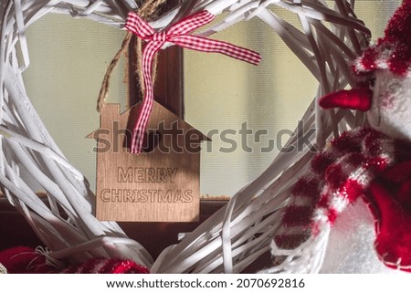 Christmas concept with snowman and heart, inside the square of the heart is written: merry christmas