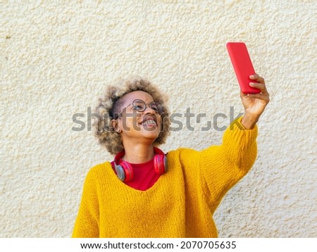 Smiling African American woman with afro hair taking a selfie