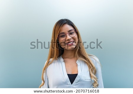 Portrait of attractive young business woman with glasses and a happy smile. Background with copy space for text