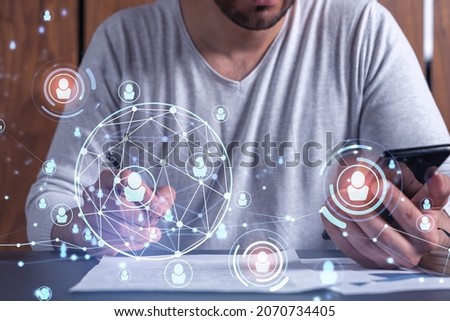 A potential employee signing the contract to boost his career and gain new opportunities in personal growth. Concept of success. Checking the detail of the deal at smartphone. Social media icons