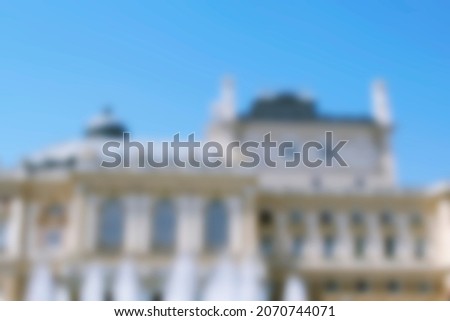 Blurred abstract unfocused selective focus of opera theatre in Odessa, Ukraine, Park outside with fountain, luxury architecture building. Travel cityscape vacation concept.