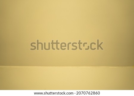Yellow studio background. Empty light room. Yellow template for advertising. Clean design for displaying product. Neutral mockup. Empty Yeloow color texture pattern cement wall studio background