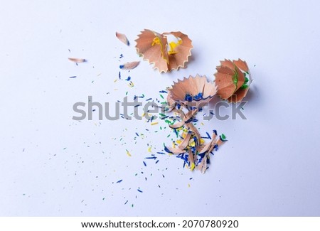Creative photo of colorful pencil shavings on a white background.