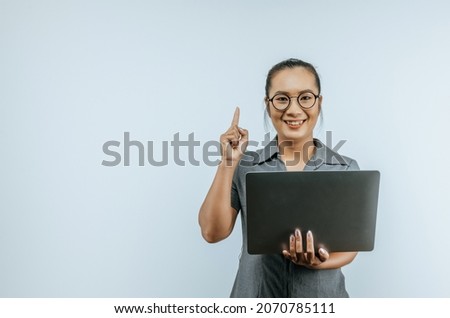 Portrait of Successful Aisan businesswoman glasses holding laptop and getting idea on isolated background. Success and SME business concept.