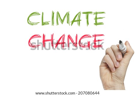 Hand writing climate change on a white board