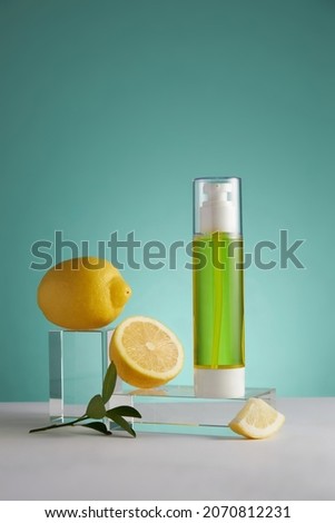 Lemon extract and cosmetic jar , lemon and sliced lemon green leaf in a blue background cosmetic template for cosmetic advertising , front view , photography experiment content  