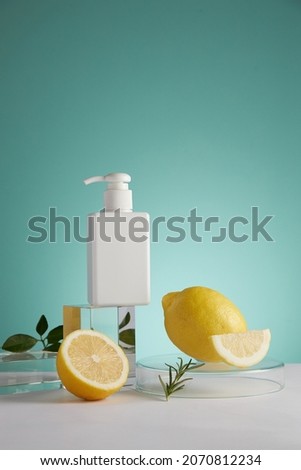 Lemon extract and cosmetic jar , lemon and sliced lemon green leaf in a blue background cosmetic template for cosmetic advertising , front view , photography experiment content  