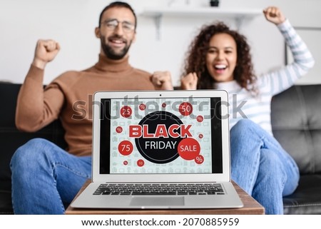Couple shopping online on Black Friday at home