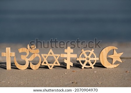 Religious symbols on sand. Christianity, Islam, Judaism, Orthodoxy Buddhism and Hinduism. Interreligious or interfaith concept.
 Royalty-Free Stock Photo #2070904970