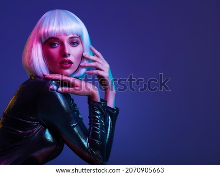 Glamour fashion girl. Beauty face with bright makeup. Young beautiful woman in a white wig, bob hairstyle. Close up art portrait  of  an young attractive woman with vivid colors. Stylish blonde. Royalty-Free Stock Photo #2070905663