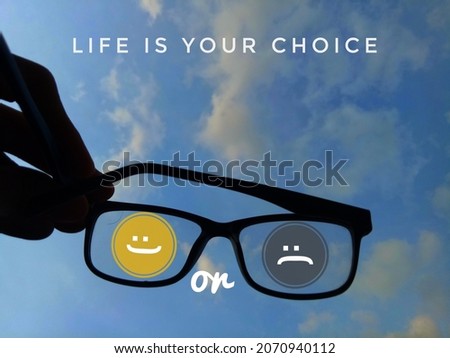 Happy and sad emoticons, expressions, feelings of the day. quote "life is your choice" on blue and cloudy sky background.