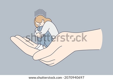 Helping hand and depression concept. Huge human hand holding tiny sitting depressed unhappy sad woman over grey background vector illustration  Royalty-Free Stock Photo #2070940697