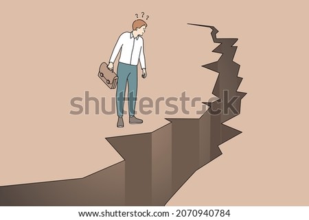 Business danger and challenge concept. Young frustrated businessman cartoon character standing looking at cracked ground abyss vector illustration Royalty-Free Stock Photo #2070940784