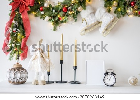 Portrait white picture frame mockup on wooden table with christmas tree . High quality photo