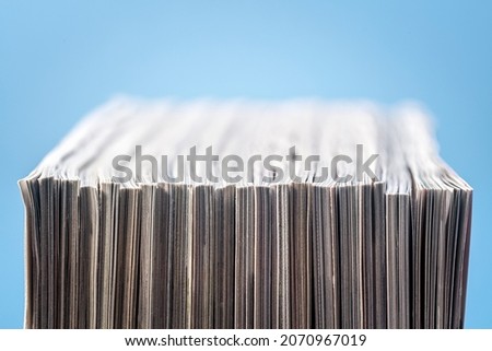 Magazine, brochure or catalogue end on against blue background Royalty-Free Stock Photo #2070967019