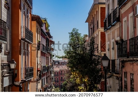 Exterior view of beautiful historical buildings in Madrid, Spain, Europe. Colorful Mediterranean street scene in the former Jewish quarter, Lavapiés, Embajadores neighborhood of the Spanish capital. Royalty-Free Stock Photo #2070976577