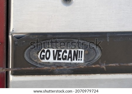 go vegan sticker on old car detail