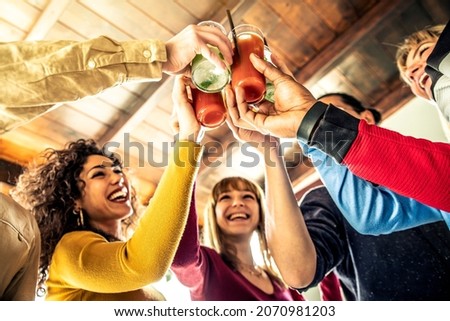 Multi ethnic friends group toasting cocktails - Happy young people having fun celebrating indoor party together - Multicultural students hanging out saturday night - Youth and friendship concept Royalty-Free Stock Photo #2070981203