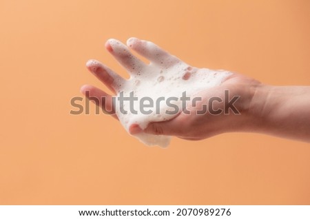 Foam in the female hand from the natural soap