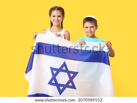 Little children with the flag of Israel on color background