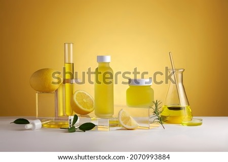 Lemon extract in test tube petri dish and lemon and sliced lemon , green leaf in a yellow background cosmetic template for cosmetic advertisin , front view , photography experiment content
