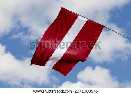Latvia flag isolated on sky background. close up waving flag of Latvia. flag symbols of Latvian.