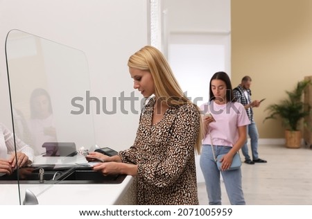 Woman with money and other people in line at cash department window. Currency exchange Royalty-Free Stock Photo #2071005959