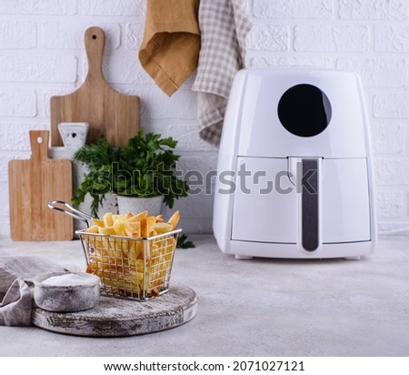 French fries cooked in air fryer. Healthy fat less food Royalty-Free Stock Photo #2071027121