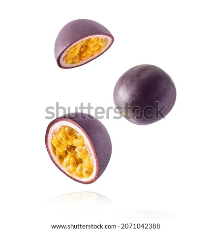 Fresh ripe raw passion fruit falling in the air isolated on white background. Zero gravity and food levitation concept. High resolution Royalty-Free Stock Photo #2071042388