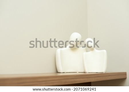 Interior design element of a statue of a couple of lovers on a shelf. Soft selective focus.