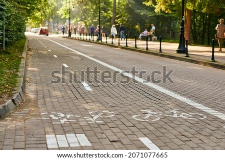 Two way cycle path and traffic car, marking bike path, white painted bicycle sign on road on street. Bike road symbol. Ride on bicycle, cycling, bicycling, wheeling and healthy lifestyle concept
