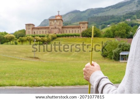 Close up view of unrecognizable man hiking the spanish Santiago way with countryside background. Horizontal view of man isolated in a travel destination in vasque country in Spain. 