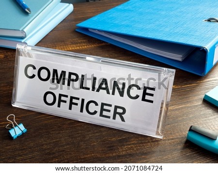 Nameplate Compliance officer on the office table. Royalty-Free Stock Photo #2071084724