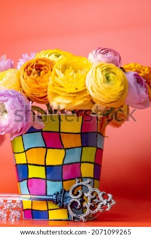 Flowers in a presentable vase on a red background Royalty-Free Stock Photo #2071099265