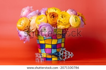Flowers in a presentable vase on a red background Royalty-Free Stock Photo #2071100786