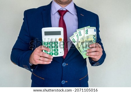 business man hold euro money and calculator, accounting or exchange concept
