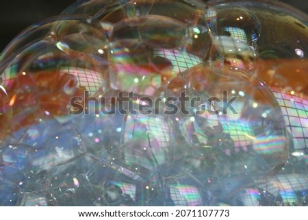 Colorful bubbles in bokeh reflect the windows forming a multicolored abstract design.