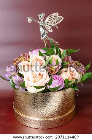 Beautiful flower arrangement with fairy decoration