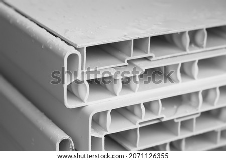 White plastic windowsill details stacked in a construction details shop, close up photo Royalty-Free Stock Photo #2071126355
