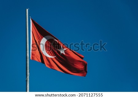 turkish flag waving in the wind with blue sky background