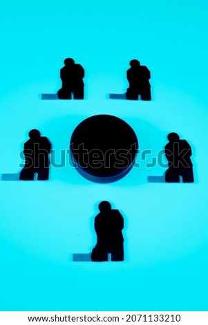 Hockey players team and puck on a blue background.