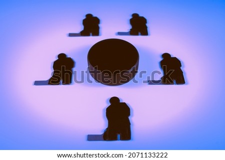Figures of five hockey players and one puck on a blue background.