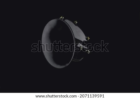 electric horn for car, snail shaped horn, isolate on black background, close-up, selective focus